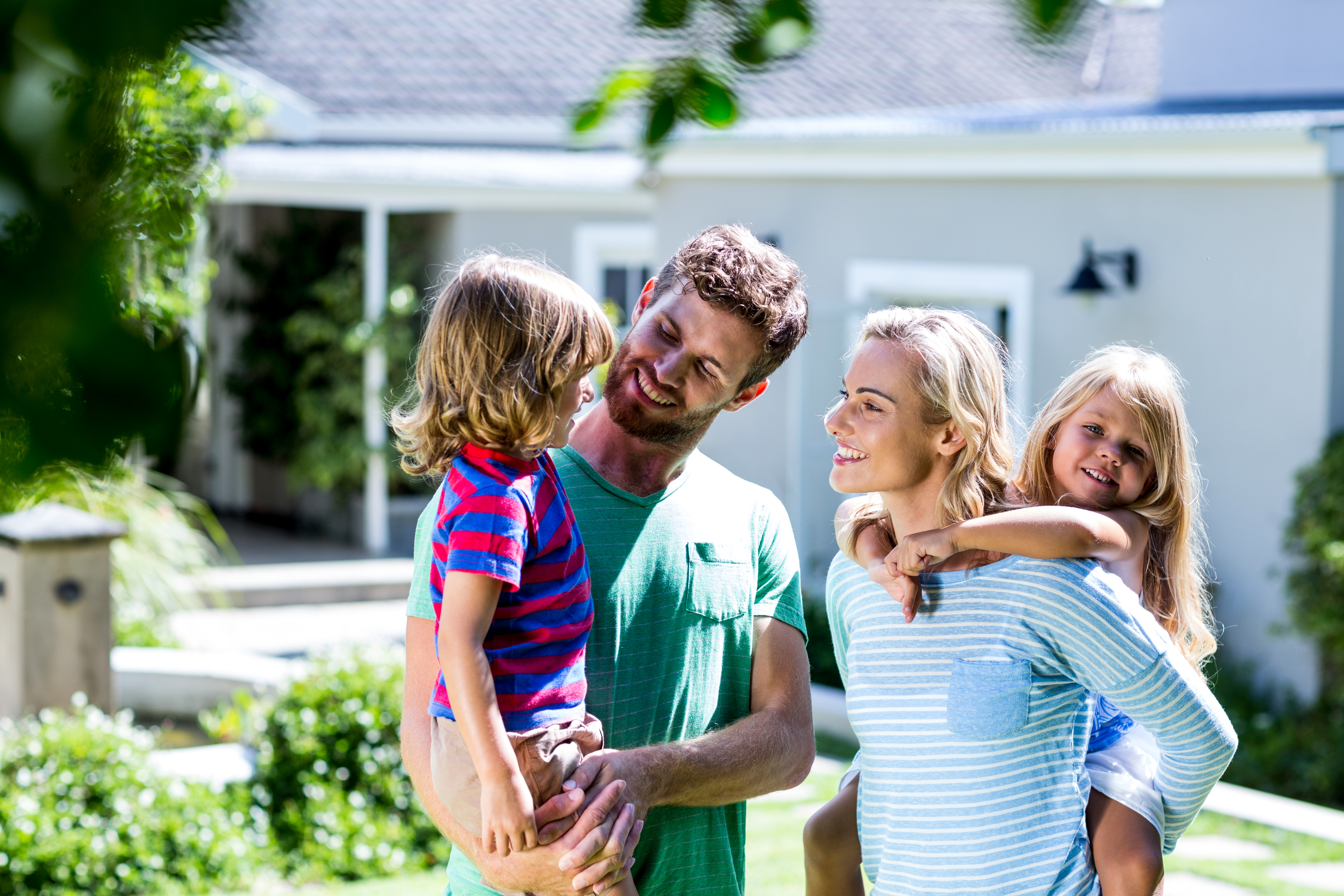 Happy family in front of their home